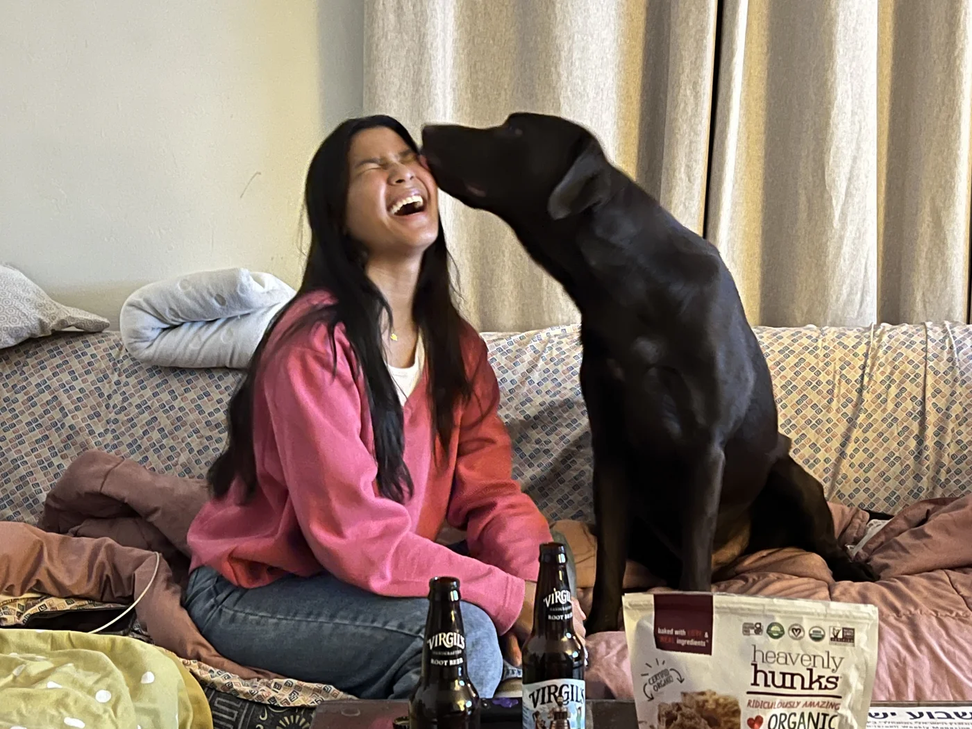 A dog leaning affectionately toward a woman